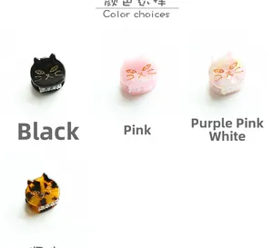 Detail view of mini cat-shaped hair claws in acetate material with four color options