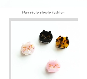 Detailed view of four mini acetate cat hair claws in pink, black, and tortoise patterns