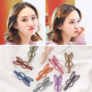 Detail of matte Morandi colored bunny ear hair clips in multiple pastel shades