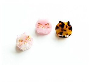 Detailed set of cute acetate cat hair clips in pink marble, solid pink, and tortoiseshell