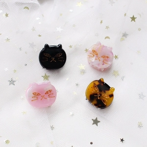 Set of four cute acetate cat hair clips in black, pink marble, and tortoiseshell patterns