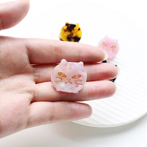 Pink marble texture acetate cat hair clip with gold detailing and delicate design