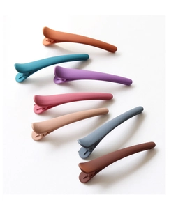 Detail showing colorful matte hair clips in seven soft morandi tones on white background