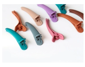 Detail view of multi-color matte duckbill hair clips with high-quality metal spring structure