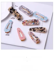 Detail of 7-piece leopard and marble pattern acetate hair clip set on white background