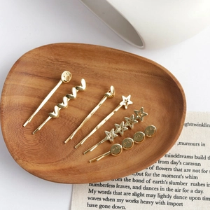 6-piece gold alloy hair clip set with heart star and smiley face designs in wood tray