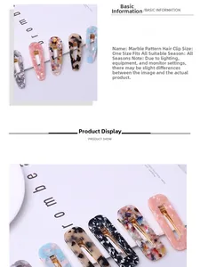Close-up of marble acetate hair clips with golden metal base on magazine background