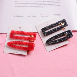 Chic acetate hair clip set in red and marble grey glitter with elegant cutout designs