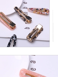 Close-up of acetate hair clips in leopard, pink and marble patterns with gold metal base