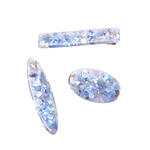 Three-piece set of light blue shell hair clips with shimmering resin and gold metal base