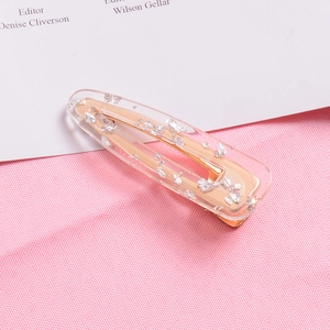 Close-up of glitter foil hair clip with clear resin and gold alloy base detail