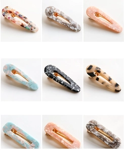 Detail of assorted tortoiseshell acetate hair clips in various marble patterns and colors