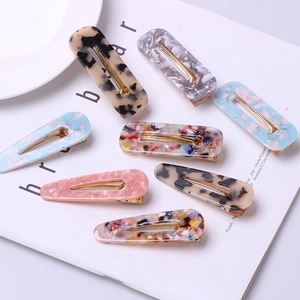 Set of 8 leopard print acetate hair clips in rectangular and teardrop shapes with gold alloy base