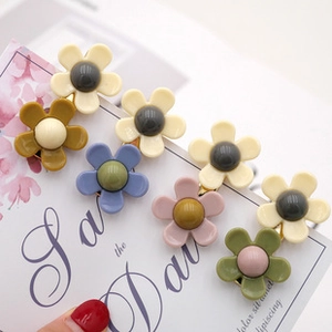 Macro view of matte flower hair claw clips in pastel macaron colors with resin texture
