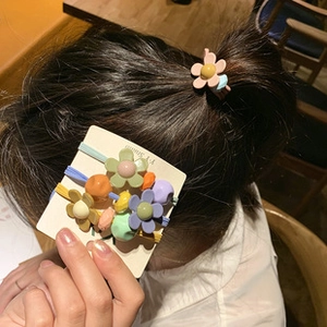 Detail of macaron colored flower hair clips and ties with a matte resin finish