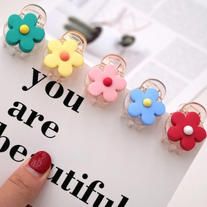Set of five colorful matte flower hair claws in mint, pink, yellow, blue and red tones