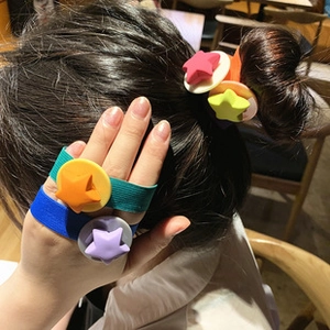 Detail of colorful matte star elastic hair ties with wide knitted bands for hair styling