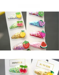 Detail of colorful fruit hair clips with glitter sequins inside transparent acrylic BB clips