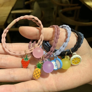 Set of four elastic woven hair ties featuring strawberry, pineapple and lemon fruit charms