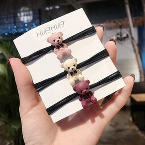 Three-piece hair ties set with stitched cartoon bear charms in pink, beige and burgundy