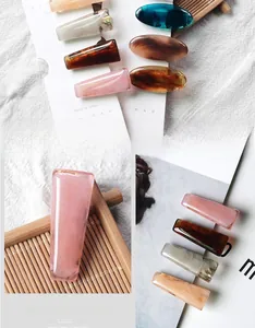 Detail of marble pattern hair clips in acetate resin with high-quality polished finish
