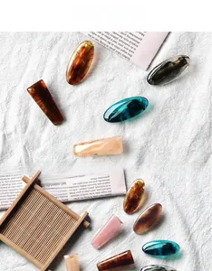 Detailed macro view of translucent resin hair clips with marble texture on fabric