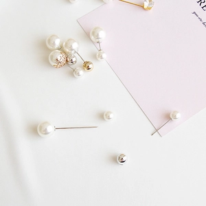 Close-up of elegant assorted pearl brooch pins in various sizes and metallic finishes