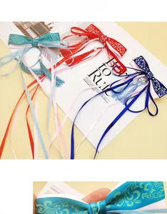Detail of silk bow hair clips with traditional Chinese floral patterns and long tassels