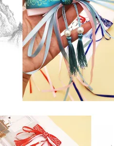 Detail of vintage Chinese style bow hairclip with silk tassels and pearl accents