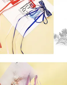 Detail of vintage Chinese bow hair clip with satin ribbon, embroidery and long tassels