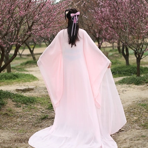 Detail of pink chiffon Hanfu dress with matching ribbon bow hair clip in cherry blossoms
