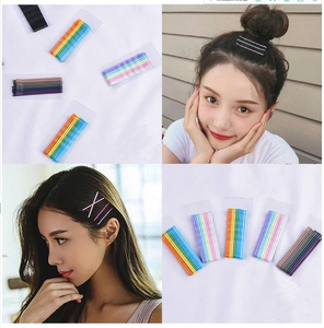 Macro detail of colorful candy-colored bobby pins shown on model hair and packaging.