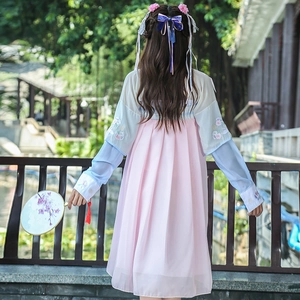 Close-up of floral embroidery on pink and light blue chiffon Hanfu dress with tassels