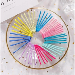 Assorted candy colors metal hair clips set neatly arranged in a gold-rimmed tray