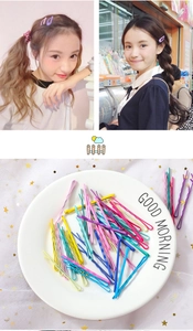 Close-up of colorful wavy candy-colored hairpins on white tray and lifestyle wear
