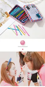 Colorful metal hairpins in a retro tin box with stylish lifestyle magazine background