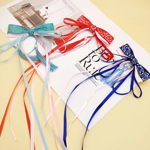 Three Chinese style bow hair clips with long tassels and pearls in red, blue, and cyan colors