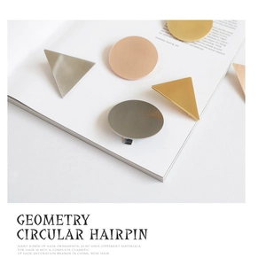 Macro detail of geometric brushed metal hairpins in gold silver and rose gold finishes