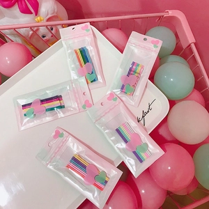 Macro view of colorful candy-colored hairpins set in heart-patterned clear packaging