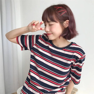 Close-up of candy-colored hair clips on a girl wearing a striped cotton T-shirt
