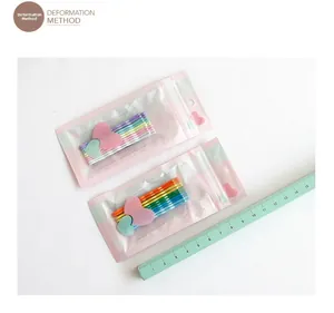 Detail view of 5cm candy-colored heart hair clips in macaron and rainbow shades with packaging