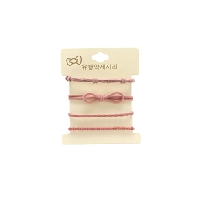 Set of 4 elastic hair ties in pink featuring a stylish bow and various textures