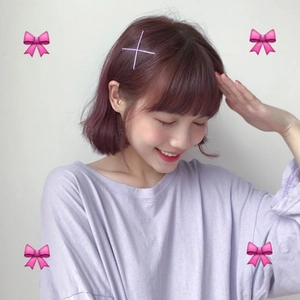 Minimalist purple matte hair clips styled in a cross shape on a female model