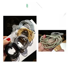Detail of colorful elastic hair ties in metallic shades with decorative cloud packaging