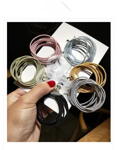 Detail view of colorful high-elastic hair ties in six shades on a display card