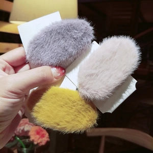 Three colorful plush faux fur BB hair clips in grey, beige, and yellow with paper card