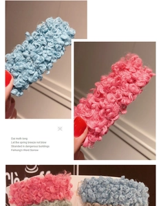 Detail of soft plush sherpa hair clips in pink and blue with cozy wool-like texture