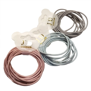Set of 10 elastic hair bands in candy colors with cute bear tags on white background