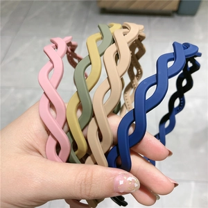 Close-up of matte braided wavy headbands in various Morandi candy colors for women