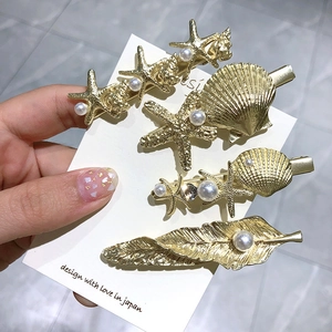 Détails de 4 barrettes dorées sur le thème de la mer avec perles et étoile de mer